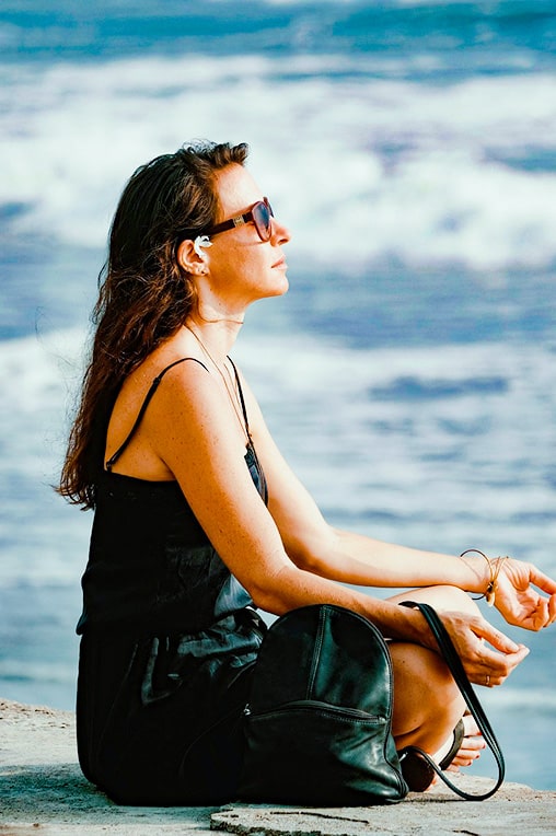 A picture of a woman doing yoga on the beach.