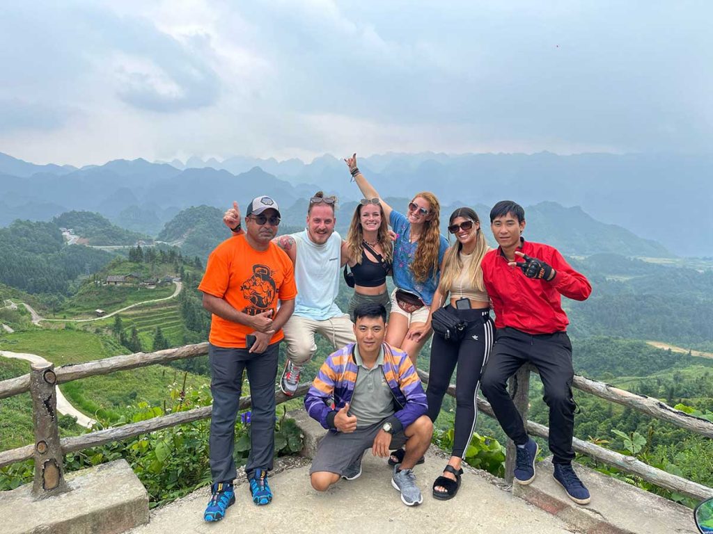 A group of travellers posing at a view point along the Ha Giang Loop