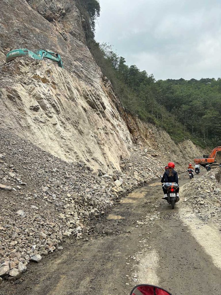 A gravel and unsteady road along the edge of a cliff on the Ha Giang Loop.