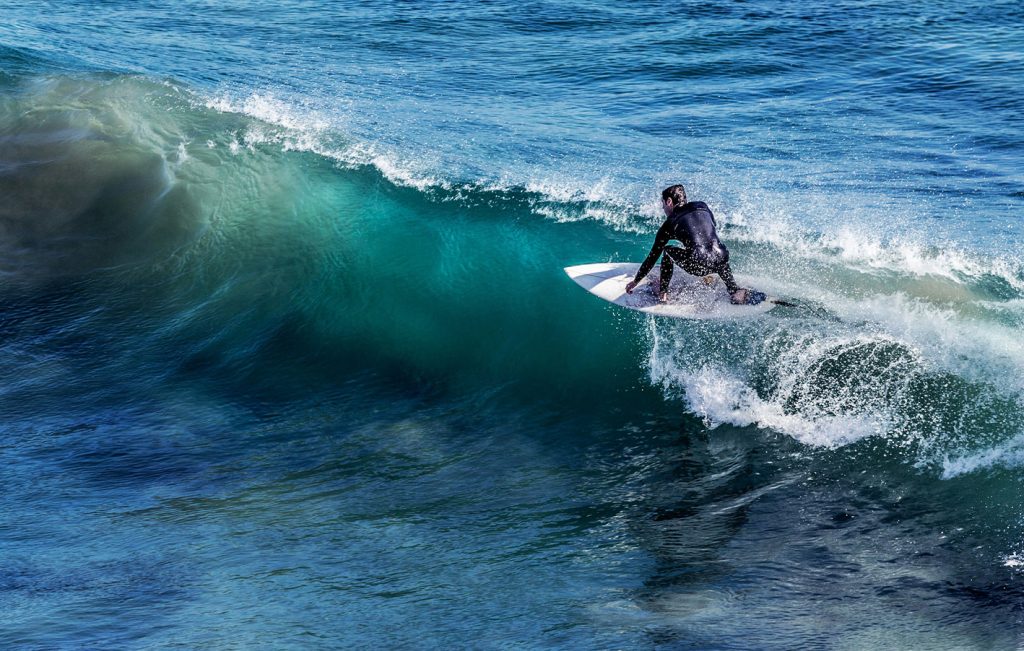 A surfer riding a powerful ocean wave in Sri Lanka’s tropical waters.

