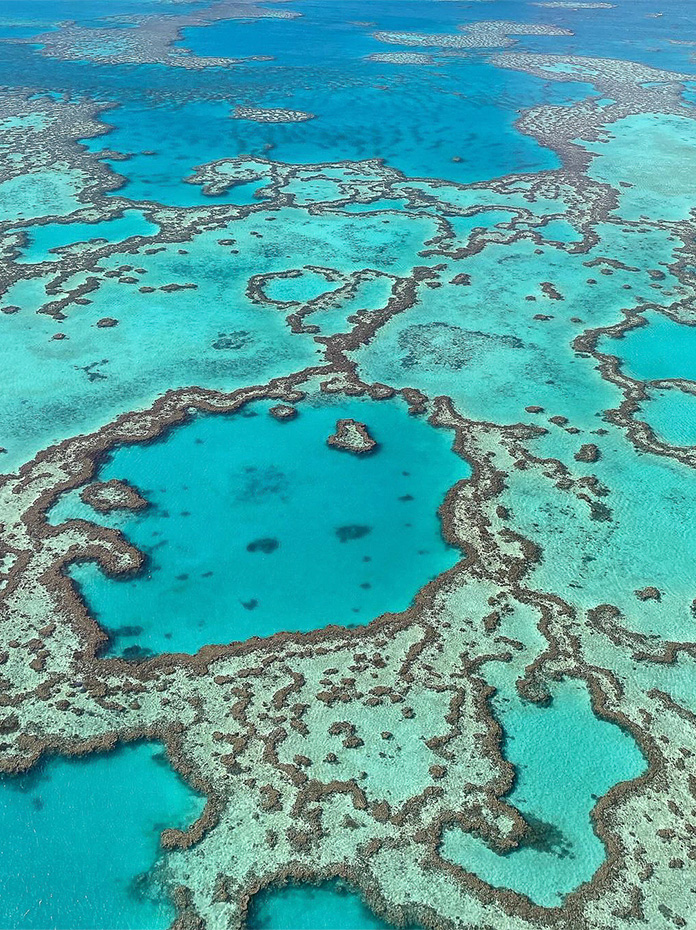 Aerial view of the famous Heart Reef surrounded by vibrant blue ocean.